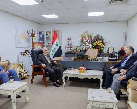 The Director General of Oil Exploration Company congratulates the Manager of the Security Permits Department on his new position